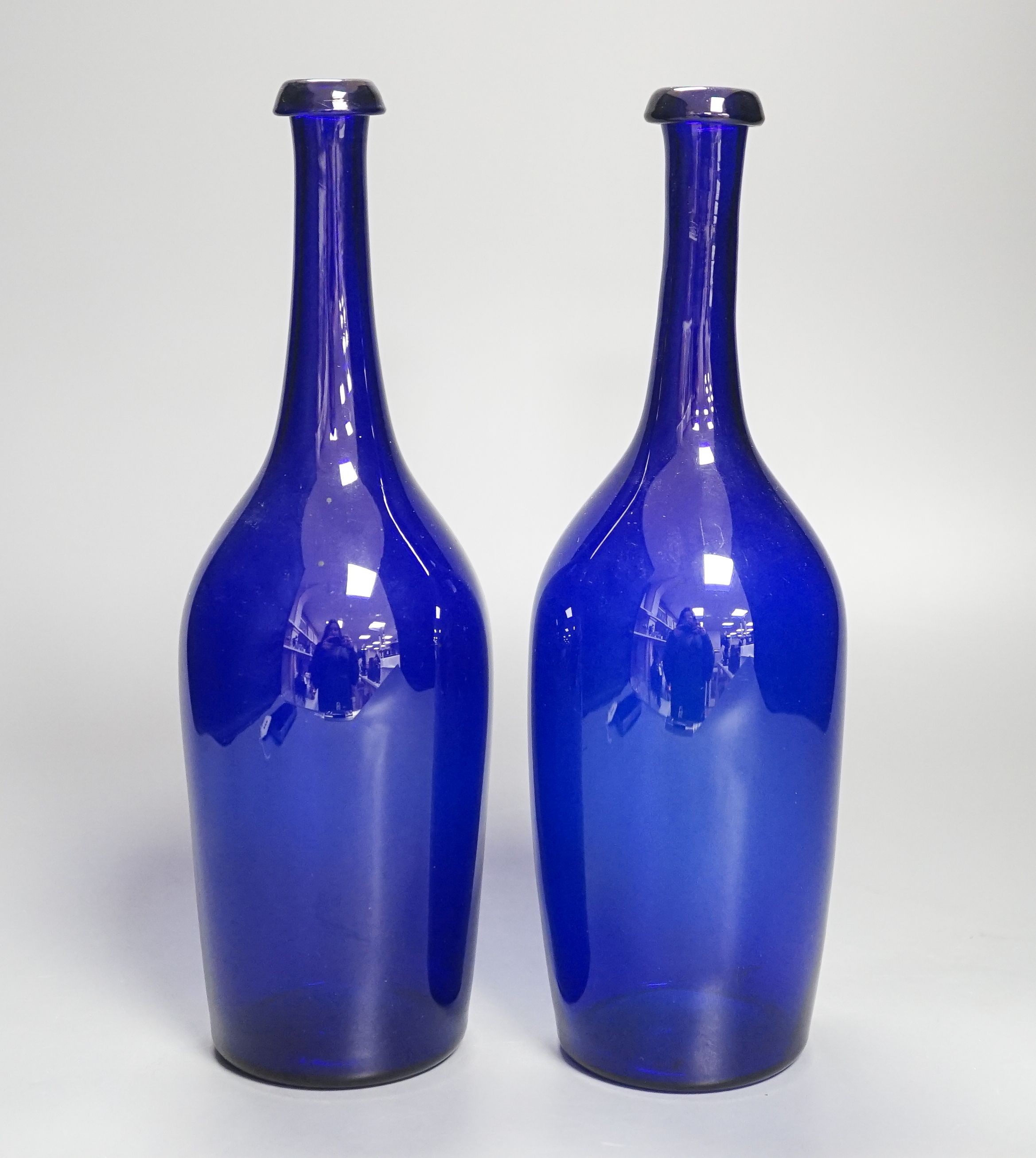 A pair of 19th century blue glass bottles 29cm